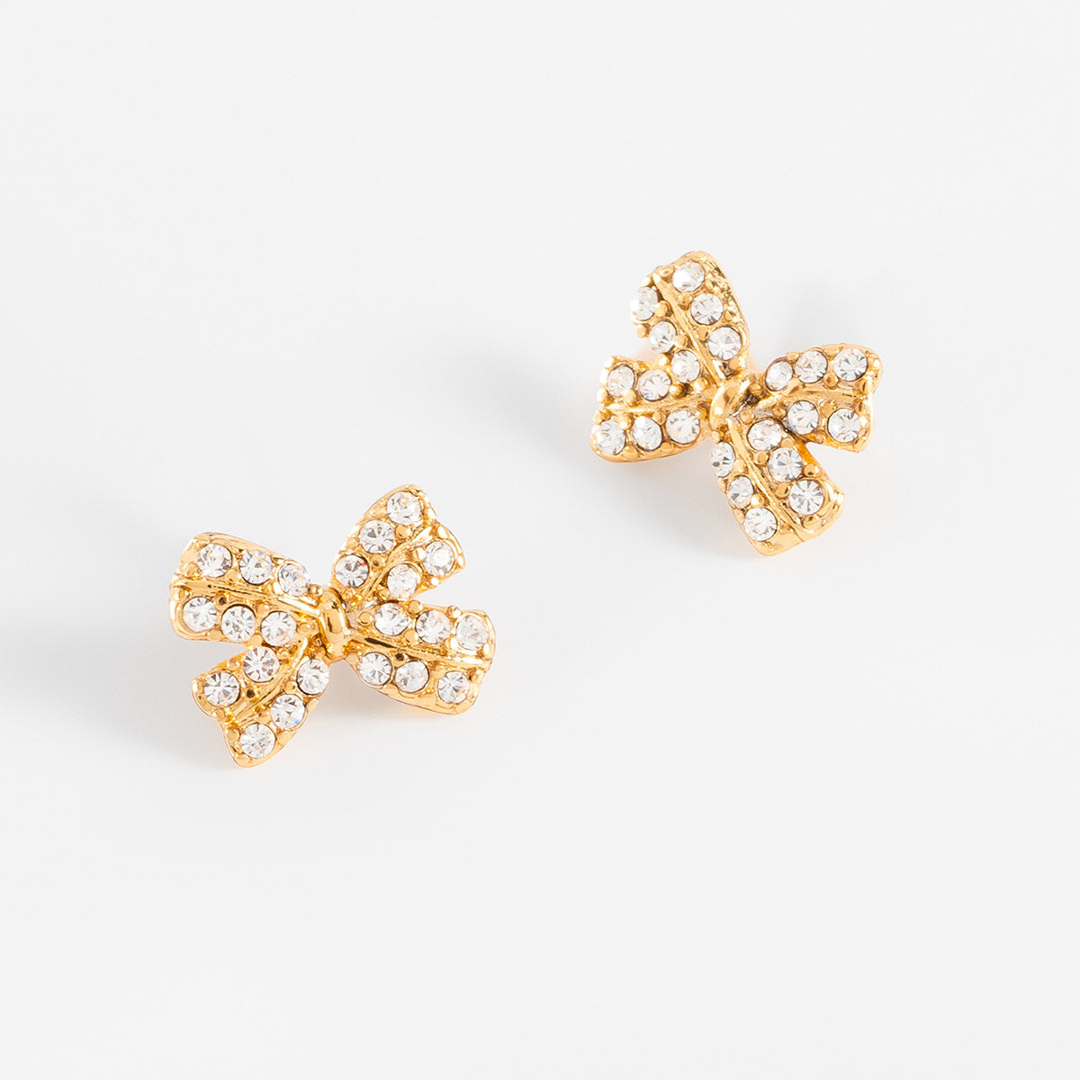 Aretes en baño de oro moño piedras toque brillante cristal