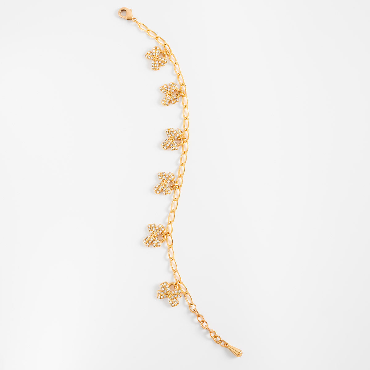 Pulsera en baño de oro dijes moño piedras toque brillante